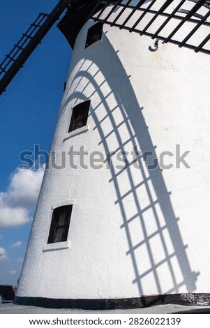 The sails of Lytham Windmill cast a shadow