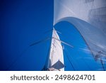 Sails of a sailing yacht in the wind sailing on the sea at sun light. High quality photo