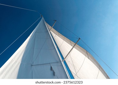 sails of a sailing yacht in the wind sailing on the ocean - Powered by Shutterstock