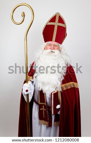 Sain Nicholas with his red costume mitre book and staff on white standing