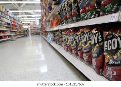 SAINSBURYS LONGSTONE, EDINBURGH, SCOTLAND - 26 September 2019 Large Packs Of Crisps On The Shelves In A Supermarket Aisle