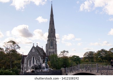 Saint Alban Church (The English Church). Built From 1885 To 1887. By A. Blomfield In Gothic Revival Style. Gefion Fountain, Donated By The Carlsberg Foundation. October 3, 2018. Copenhagen, Denmark. 