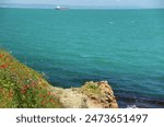 Saint Anastasia Island (Sveta Anastasia). Lighthouse, residential buildings and azure sea. Burgas Bay, Black Sea, Bulgaria, EU. April 27, 2024.