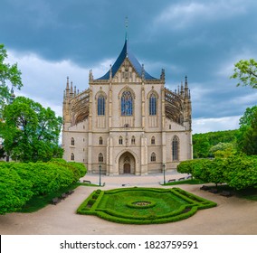 Saint Barbara's Church (Cathedral of St Barbara) Roman Catholic church Gothic style building facade, flowerbed with bushes in Kutna Hora historical Town Centre, Central Bohemian Region, Czech Republic