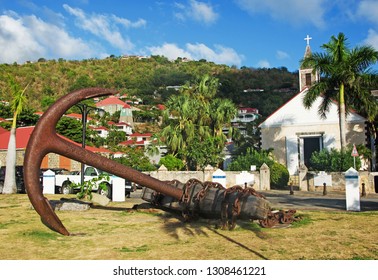 Saint Barthelemy (St Barth, St. Barths Or St. Barts), Caribbean Sea, Greater Antilles, April 14, 2015: A Giant Anchor In The Grass In Front Of The St Bartholomew's Anglican Church In Gustavia