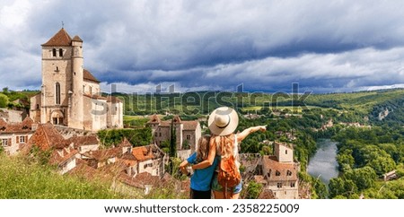 saint cirq lapopie village, mother and son looking at panoramic view- Lot, Occitanie in France