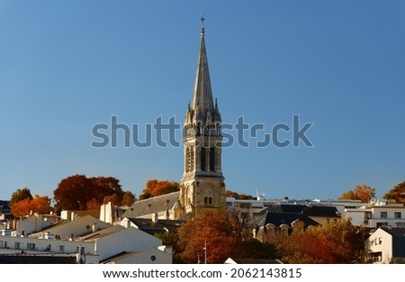 The Saint Clodoald church and autumn trees. It was built in 1815-1892 in a Romanesque Gothic style . The first stone was laid by queen Marie-Antoinette in 1787. Saint Cloud town. France.