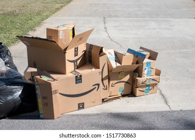 Saint Cloud, Florida / USA - September 23, 2019: Amazon Smile Delivery Boxes And Yard Waste At The Driveway Curb; For Garbage Pick Up  