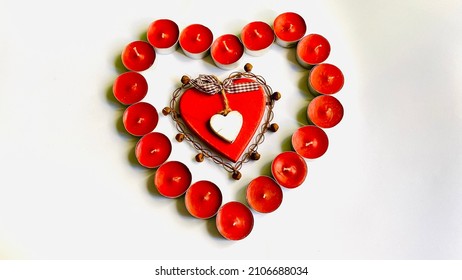 Saint Valentine’s Day With Red Tea Light Candle And Red Wooden Big Heart With White Wooden Little Heart, View From Above, Isolated White Background