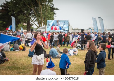 Saint Gilles Croix de Vie, France - July, 10, 2016 : In the fan zone of the city, supporters of french team waiting for the match of the final of Euro 2016. Waving French flags
