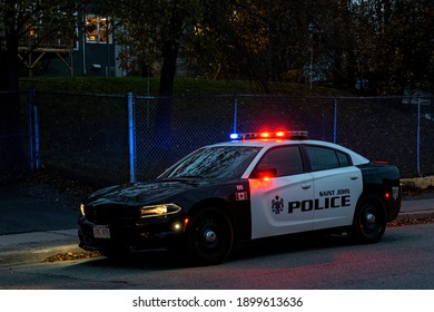 Saint John, NB, Canada - October 31, 2020: A Police Car At The Side Of The Road After Sunset. The Red And Blue Lights Are Illuminated.