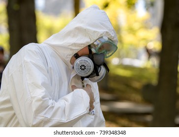 Saint John, New Brunswick, Canada - October 21, 2017: Zombie Walk In Support Of Romero House, The Local Soup Kitchen. A Man Wears A White Environmental Safety Suit And Gas Mask.