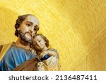 Saint Joseph and baby Jesus of the Catholic Church - Sao Jose - Menino Jesus - St Joseph yellow background