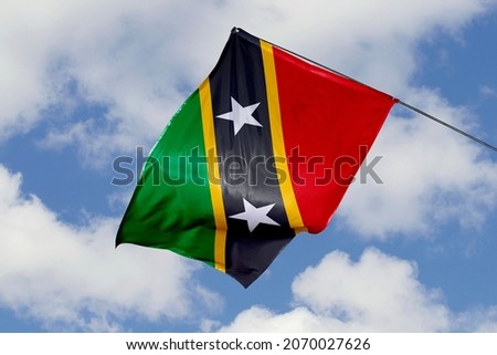 Saint Kitts and Nevis flag isolated on sky background. close up waving flag of Saint Kitts and Nevis. flag symbols of Saint Kitts and Nevis.