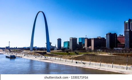 Saint Louis, Mo—Feb 24, 2019; View Of Saint Louis Arch And St Louis Skyline Along The Mississippi River Bank Downtown With Clear Winter Sky.