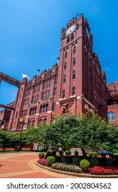 Saint Louis, MO—July 3, 2021; View Of Iconic Brew House Clock Tower At Anheuser Busch Brewery In Soulard With Landscaping In Foreground.