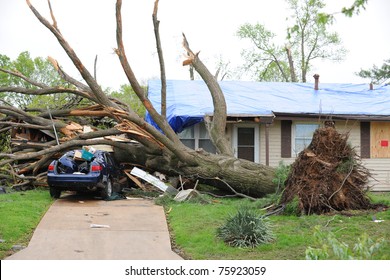 SAINT LOUIS, MISSOURI - APRIL 23: Damaged home with tarp-covered roof after tornadoes hit the Maryland Heights area on Friday April 22, 2011 in Saint Louis, Missouri.