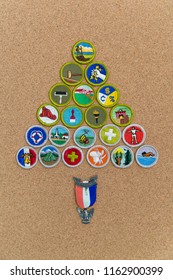 SAINT LOUIS, UNITED STATES - AUG 22, 2018:  A Pyramidal Arrangement Of Boy Scouts Of America (BSA) Merit Badges With Eagle Pin On Cork Background