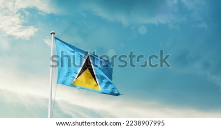 Saint Lucia national flag waving in beautiful sky.