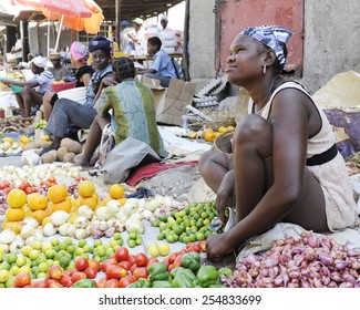 SAINT MARC, HAITI - FEBRUARY 22, 2013:  Women selling fruits and veggies along the street in St. Marc, Haiti.