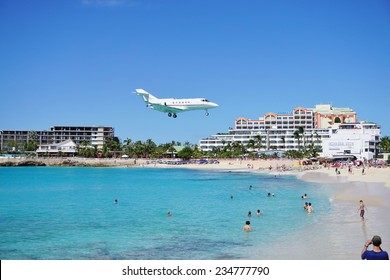 SAINT MARTIN, DUTCH ANTILLES --30 NOVEMBER 2014-- The beach at Maho Bay is one of the world's premier planespotting destinations. Airplanes landing at the Princess Juliana Airport fly over beachgoers.