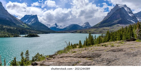 Saint Mary Lake at Sun Point - A panoramic overlook of Saint Mary Lake and its surrounding rugged high mountain peak at Sun Point on a stormy Spring afternoon. Glacier National Park, Montana, USA. - Shutterstock ID 2021244389