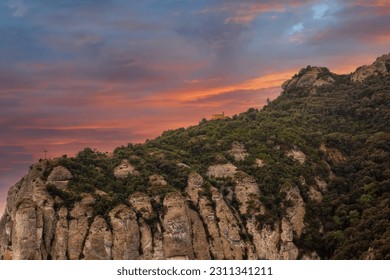 Saint Michaels Cross, sits on the edge of the mountains in Montserrat, near Barcelona, Spain - Shutterstock ID 2311341211