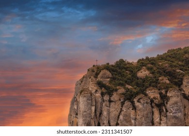 Saint Michaels Cross, sits on the edge of the mountains in Montserrat, near Barcelona, Spain - Shutterstock ID 2311341507