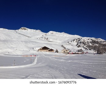 Saint Moritz, St Moritz, Switzerland . January 2014 Ski Slopes And Mountain Rocks In Swiss Alps With Restautant Chalet For Lunch And After Ski Party.