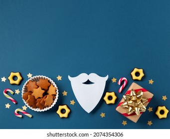 Saint Nicholas Day, 6 December. Christmas composition with sweets, candy, gingerbread cookies and gifts on dark blue background, top view. Traditional winter holiday in Germany and Western Europe. - Powered by Shutterstock