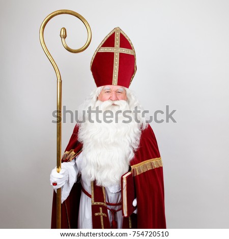 Saint Nicholas standing with his staff on white