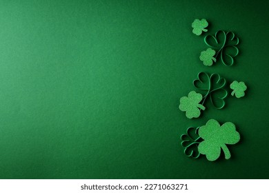 Saint Patrick day flat lay concept with shamrock clover on green background, top view, copy space - Shutterstock ID 2271063271