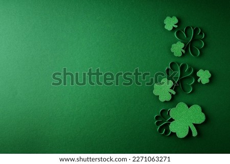 Saint Patrick day flat lay concept with shamrock clover on green background, top view, copy space