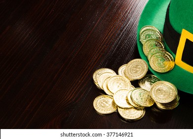 Saint Patrick's gold coins and green hat - Powered by Shutterstock
