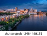 Saint Paul, Minnesota, USA. Aerial cityscape image of downtown St. Paul, Minnesota, USA with reflection of the skyline in Mississippi River at stormy summer sunset.