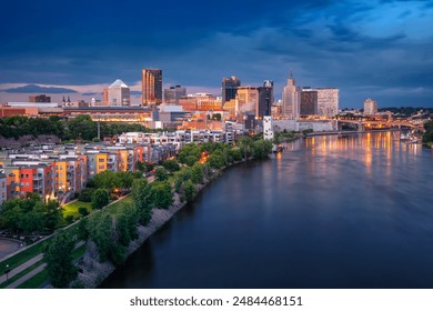 Saint Paul, Minnesota, USA. Aerial cityscape image of downtown St. Paul, Minnesota, USA with reflection of the skyline in Mississippi River at stormy summer sunset.