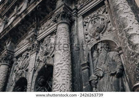 Saint Paul with sword and book Bible. An architectural element under the bas-relief of the Boim Chapel. Old carving on the surface of alabaster. Lviv, Ukraine.