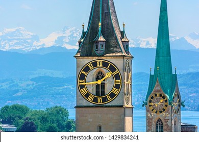 Saint Peter And Fraumünster Church In Zurich (Switzerland) In Front Of Lake Zurich And The Swiss Alps