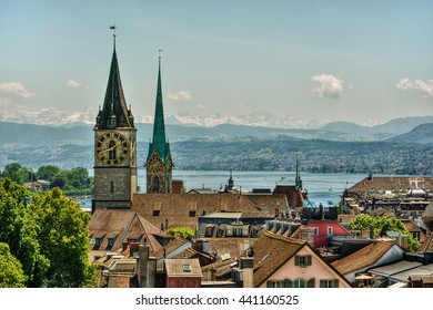 Saint Peter And FraumÃ¼nster Church In Zurich (Switzerland) In Front Of Lake Zurich And The Swiss Alps, HDR-technique