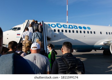 Saint Peterburg, Russia / 2020.08.14 / People Queuing To Board The Airline Plane Pobeda