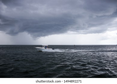 Saint Petersburg, FL, USA - 7/19/2019: A Boat Speeds In Tampa Bay As Ominous Storm Cloud Build During The 2019 Atlantic Hurricane Season. 