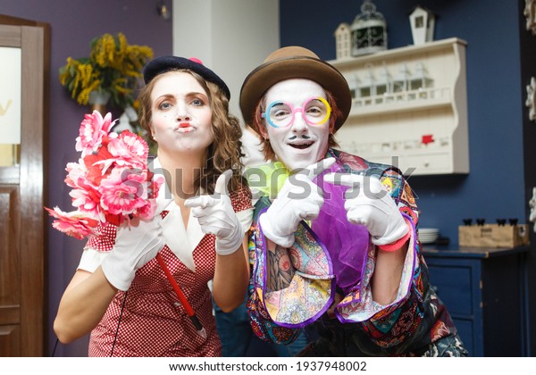 \
Saint Petersburg, Russia - 08 March 2021: Cheerful\
mimes animators at a banquet in a restaurant in honor of the 8\
March holiday, mimes are invited to entertain guests. Theatrical\
art in life