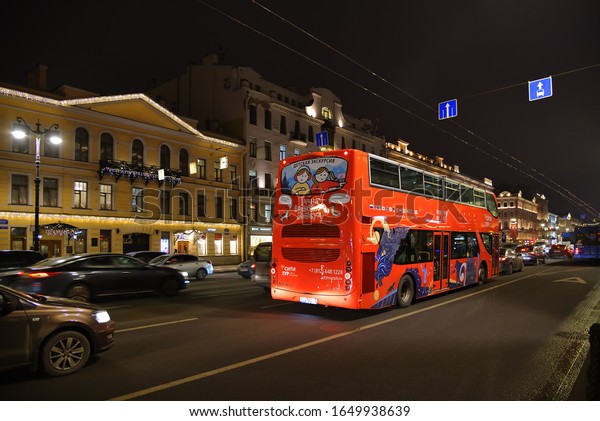 Saint\
Petersburg, Russia - January 30, 2020: Urban landscape at night.\
Red double decker excursion bus on Nevsky avenue. Nevsky Prospect\
is the main street in St Petersburg\
city