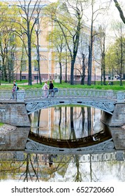 SAINT - PETERSBURG, RUSSIA - MAY 18, 2017: People On The Bridge Over The Pond In The Mikhaylovsky Garden Next To The Mikhaylovsky Palace (Russian Museum)