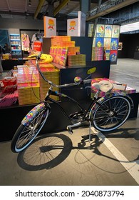 Saint Petersburg, Russia - September 12, 2021. A Colorful Bicycle, Shelves Of Books And Souvenirs At The Andy Warhol Exhibition. Editorial Use Only.