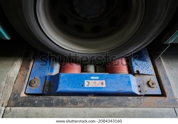 Saint\
Petersburg, Russia - September 30, 2021: Car wheels on a power\
roller test bench during a bus brake system\
test.