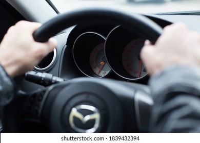 Saint Petersburg / Russia-October, 15, 2020: Confident Male Driver Holds The Steering Wheel Of A Mazda Car. Comfortable Driving Concept, Men's Hands Close-up, Horizontal Photo