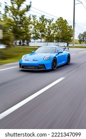 SAINT PETERSBURG, UNITED STATES - Jun 05, 2022: A Vertical Shot Of A Blue Porsche 911 GT3 Sportscar In Motion