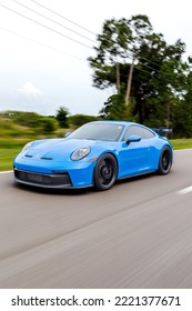 SAINT PETERSBURG, UNITED STATES - Jun 05, 2022: A Vertical Shot Of A Blue Porsche 911 GT3 Sportscar In Motion