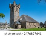 Saint Pierre church in a village of the same name in Normandy, France. Built entirely of granite, the church is flanked by a square tower topped by four clochetons.